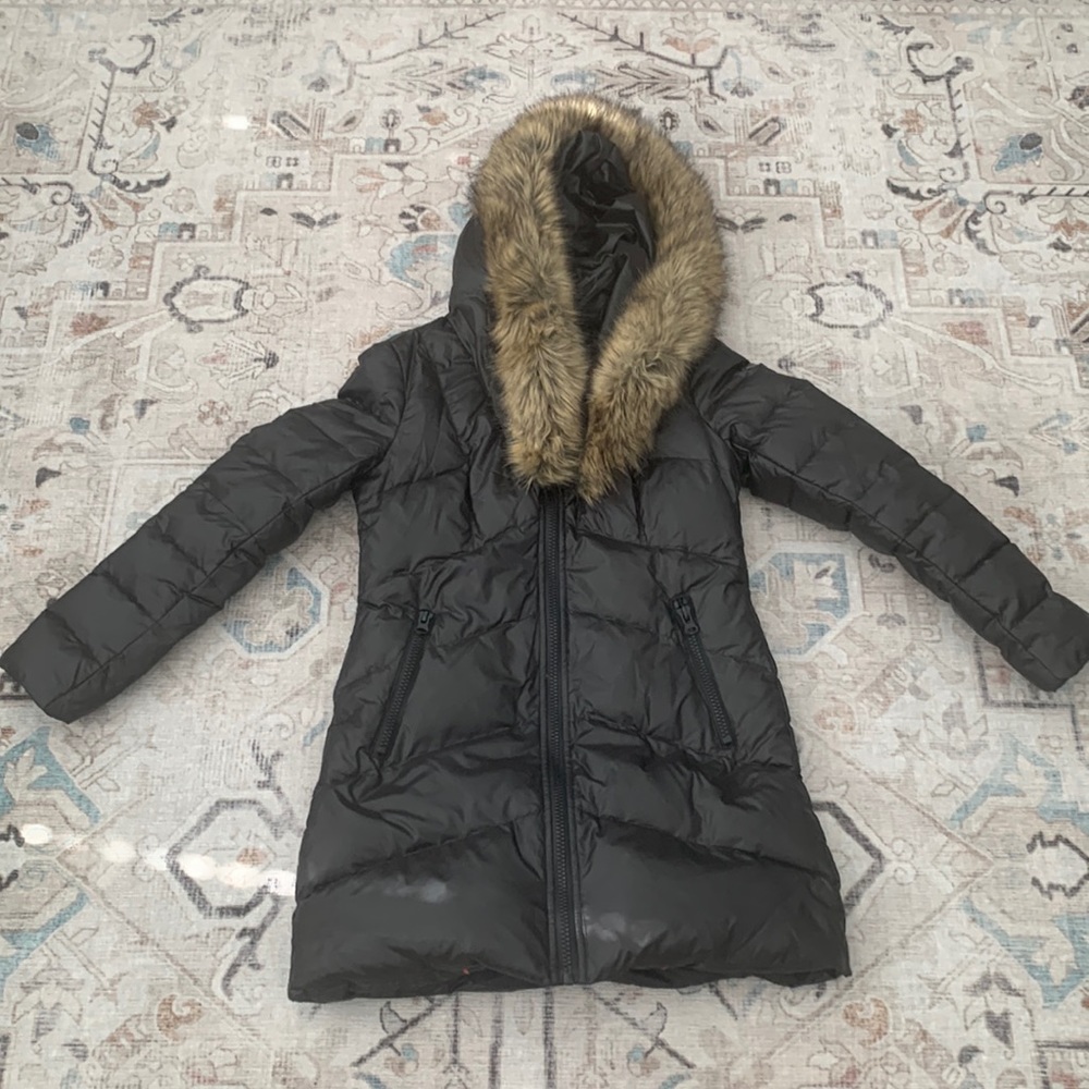 Black puffer jacket with faux fur hood.